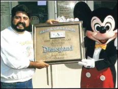 Dale Castillo receives the first publicly circulated Disney Dollar, 1987