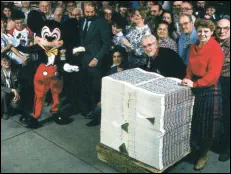 Mickey mouse, receiving the very first Disney Dollars