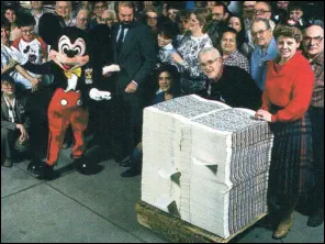 Mickey mouse, receiving the very first Disney Dollars